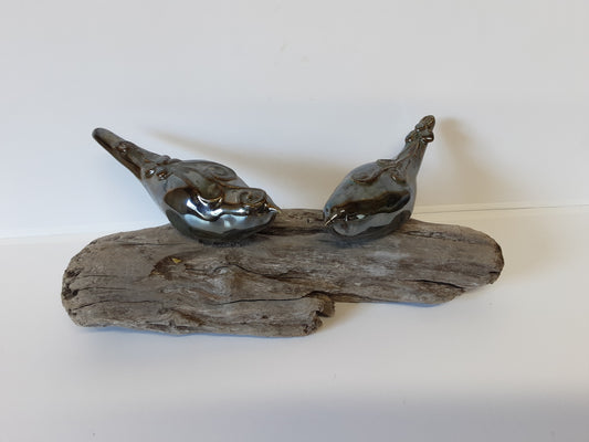 Ceramic birds on driftwood