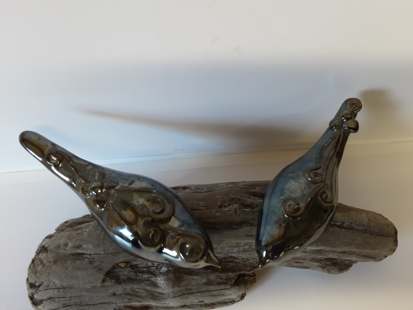 Ceramic birds on driftwood