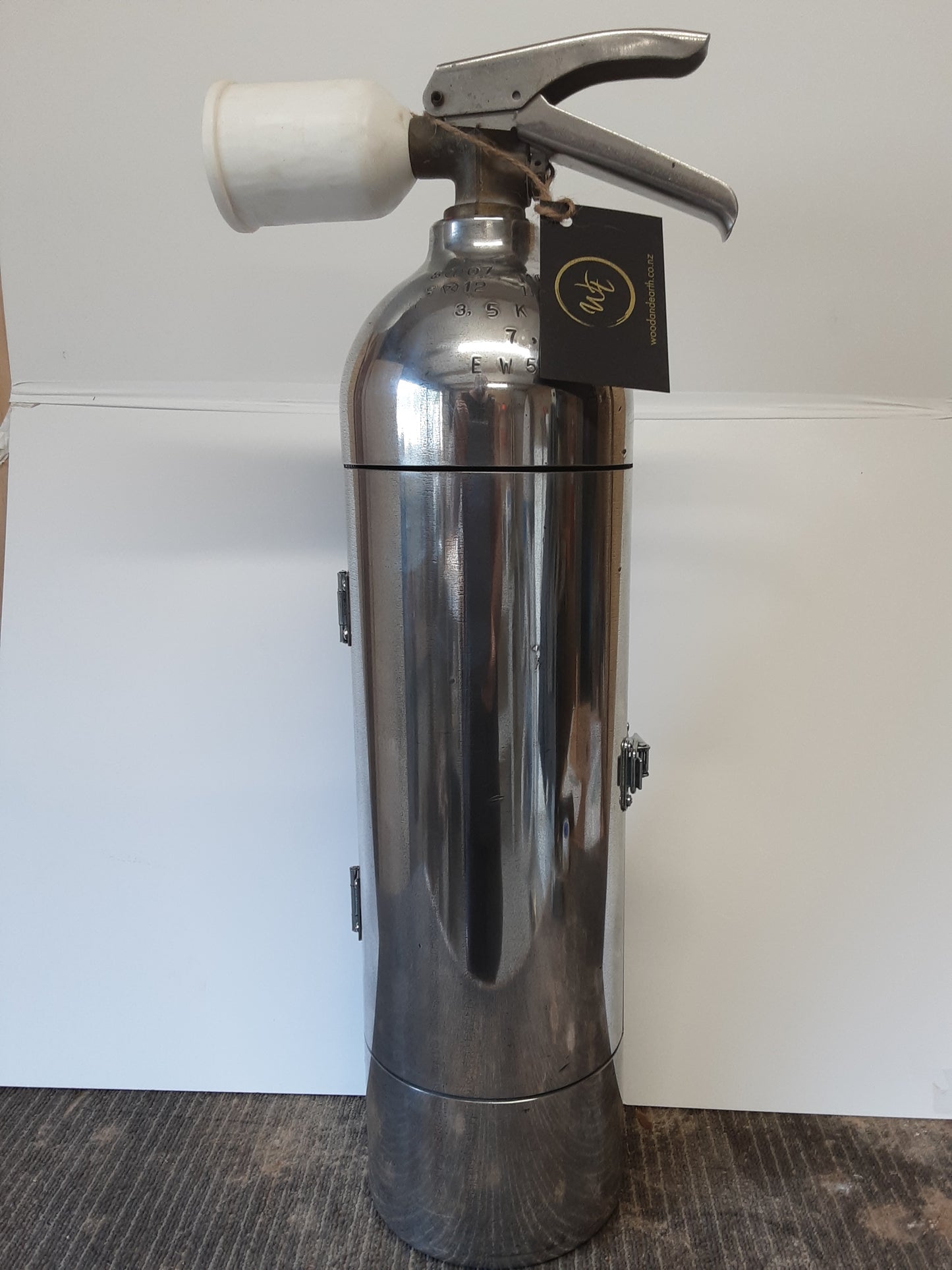 Whiskey bottle holder/fire extinguisher